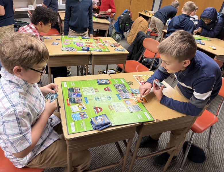 Students playing the Pok&eacute;mon Trading Card Game in a classroom during Pok&eacute;mon Club at OLPI.