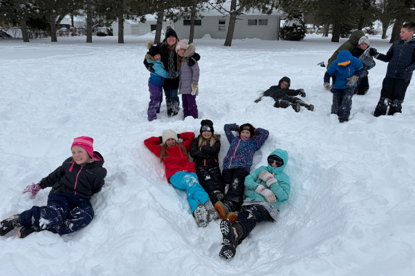 Students having fun in the snow during recess at Our Lady of Peace Intermediate School.