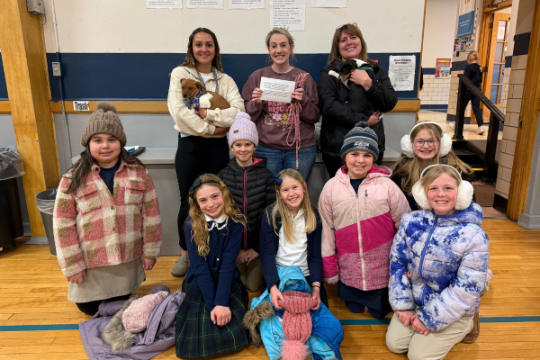 Our Lady of Peace Intermediate School students and teachers with puppies from Copper Paws Rescue.